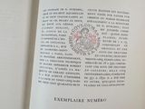 a person holding a book open on a table