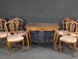 four chairs and a table with a wooden table and four chairs