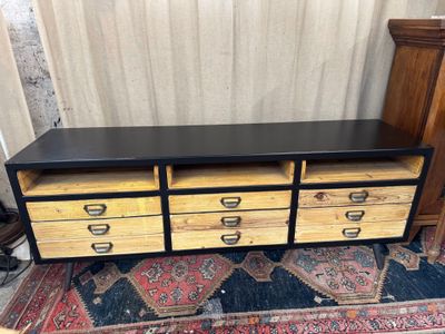 a black and yellow chest of drawers on a rug