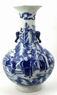 a blue and white vase with a mountain scene on it