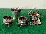 four silver objects on a green surface