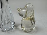 two glass figurines that are sitting next to each other