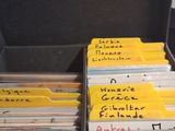 many folders in a suitcase with writing on them