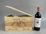 a wooden box with a bottle of wine in it