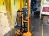 a yellow fork lift truck parked in a warehouse