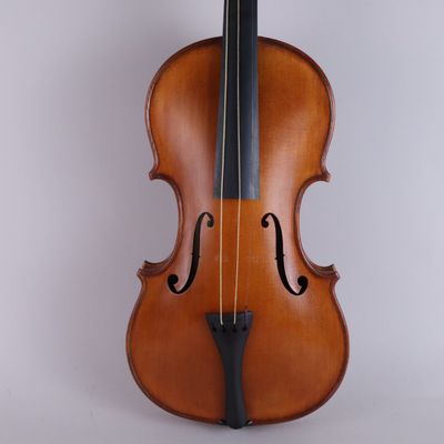 an old violin sitting on top of a white surface