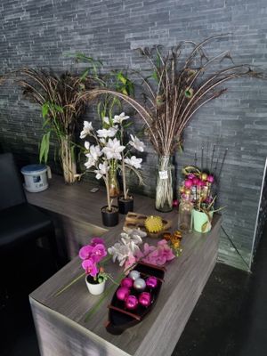 several vases of flowers are sitting on a table in a room