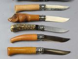 six different types of knives are lined up on a table