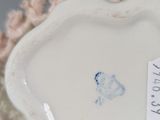 a small white plate with a blue flower on it