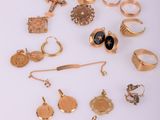 a lot of gold rings and rings on a white surface