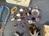 a lot of jewelry sitting on a table together
