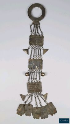 an image of a metal object hanging on a white wall