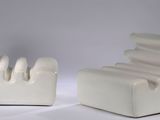 a white chair and a chair that are sitting next to each other
