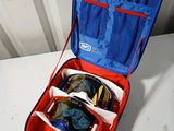 a red and blue suitcase with sunglasses in it on a table