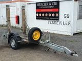 a trailer with a trailer attached to it in front of a building