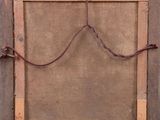 an old wooden frame with a rope hanging from it ' s side