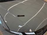 a close up of the hood of a car with a sticker on it