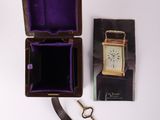 a box with a watch and a pair of scissors next to it