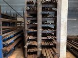 a large amount of steel bars stacked up in a warehouse