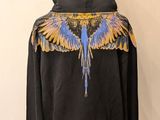 black hooded jacket with blue and yellow wings on the back