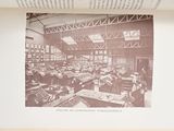 an old picture of a factory with people working on machines