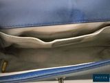 the inside of a blue purse with a zipper on the inside