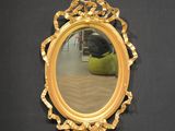 a mirror that is hanging on the wall next to a chair