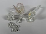 a lot of glass figurines sitting on a white surface