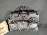 an image of a black leather purse with a small bag next to it