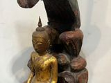 an image of a statue of a woman sitting on a rock