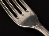 a fork that is sitting on a black table