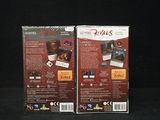 two boxes of video games sitting on a black surface