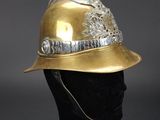 a close up of a gold fireman ' s helmet on a mannequin head
