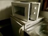 a microwave and a sink in a small kitchen