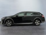 the black car is parked on the concrete floor in the room