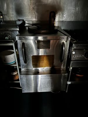 a stove with a pot on top of it in a kitchen