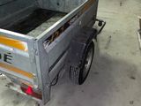 an image of a small trailer in a garage