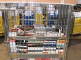 a metal cart with many books on it in a warehouse