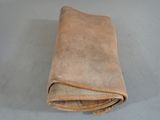a brown leather wallet on a table with a white background