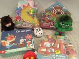 a lot of toys and books on the floor