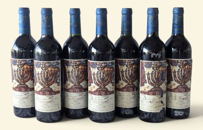 six bottles of wine are lined up in a row on a table