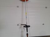 an image of a string trimmer in a garage