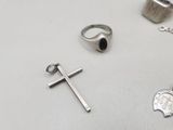 a silver cross, a ring, a ring, and a ring with a cross on it