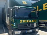 two trucks parked next to each other in front of a building