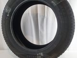 tires on a white surface with a white curtain in the background