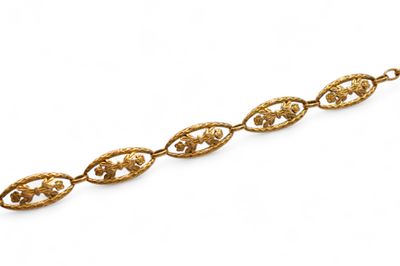 a close up of a gold chain on a white background