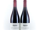 two bottles of wine sitting next to each other on a white surface
