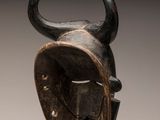 statue of a bull ' s head with horns on a black stand
