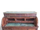 a wooden desk with a glass top and drawers on it