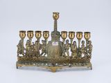 an image of a brass menorah with a group of people on it